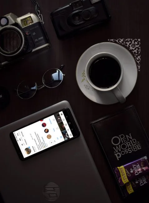 heros-img Person relaxing indoors with coffee and smartphone, texting in a cozy setting.